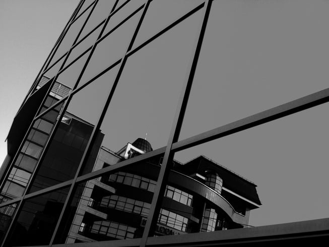 Grayscale Photo Of Glass Curtain Building